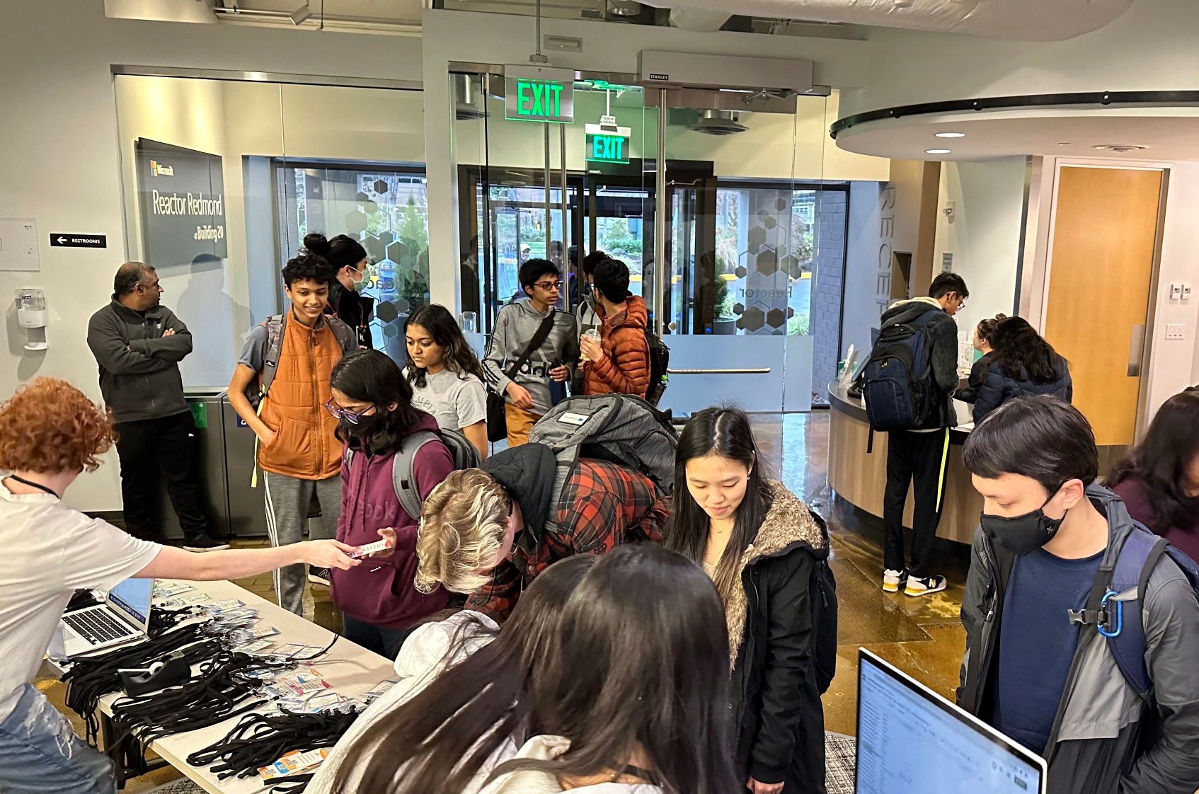 Photo of attendees collecting their name tags at the entry